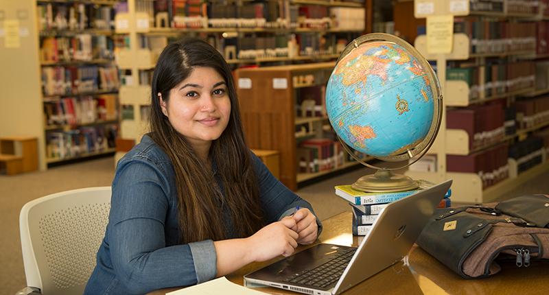 Female international student posing in Milner Library.